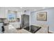 Modern kitchen features stainless steel appliances and white cabinets at 9 Haig Pl # 806, Dunedin, FL 34698