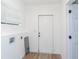Laundry room with vinyl flooring, built-in cabinets, and access door at 1616 18Th Street E Ct, Palmetto, FL 34221
