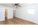 Bright bedroom with wood-look floors, ceiling fan, and ample closet space at 1616 18Th Street E Ct, Palmetto, FL 34221