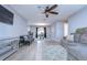Open concept living room and dining area with gray sectional sofa and wood-look floors at 9252 81St Ave, Seminole, FL 33777
