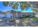 Charming ranch house with mature landscaping and a white garage door at 9252 81St Ave, Seminole, FL 33777