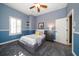 Cozy bedroom with gray platform bed and yellow pillows at 667 Richmond Close, Tarpon Springs, FL 34688