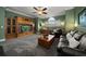 Media room with built-in entertainment center and seating at 667 Richmond Close, Tarpon Springs, FL 34688
