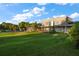 Building exterior showcasing a large lawn and partial view of a golf course at 667 Richmond Close, Tarpon Springs, FL 34688