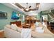Spacious living area with a large sectional sofa and hardwood floors at 667 Richmond Close, Tarpon Springs, FL 34688