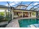 Expansive pool and patio with covered seating area at 667 Richmond Close, Tarpon Springs, FL 34688