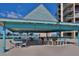 Community rooftop patio with bar seating offering an ocean view in a relaxing atmosphere at 1 Key Capri # 102E, Treasure Island, FL 33706