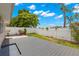 Private backyard features a wooden deck, grassy area, and a white fence, perfect for outdoor living at 3226 Cloverplace, Palm Harbor, FL 34684