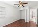 Bright bedroom features hardwood flooring, ceiling fan, and a closet at 3226 Cloverplace, Palm Harbor, FL 34684