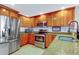 Modern kitchen with stainless steel appliances and wood cabinets at 51 Island Way # 800, Clearwater Beach, FL 33767