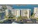 Condo building with parking lot in front and waterfront view at 7979 Sailboat Key S Blvd # 506, South Pasadena, FL 33707