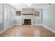 Living room with whitewashed brick fireplace and wood-look flooring at 2347 Eastwood Dr, Clearwater, FL 33765