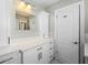 Updated bathroom with white cabinets, quartz countertops, and a large mirror at 2347 Eastwood Dr, Clearwater, FL 33765