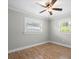 Bright bedroom featuring hardwood floors and ceiling fan at 2347 Eastwood Dr, Clearwater, FL 33765