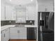 Modern kitchen with white cabinets, double sink, and stainless steel appliances at 2347 Eastwood Dr, Clearwater, FL 33765