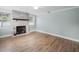 Living room featuring a whitewashed brick fireplace and hardwood flooring at 2347 Eastwood Dr, Clearwater, FL 33765