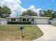 Charming ranch house with a well-manicured lawn and driveway at 2347 Eastwood Dr, Clearwater, FL 33765