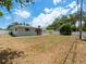 View of the home's backyard, showcasing a large grassy area at 2347 Eastwood Dr, Clearwater, FL 33765