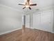 Hardwood floor bedroom with ceiling fan and double door closet at 2347 Eastwood Dr, Clearwater, FL 33765