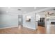 Open concept living room with kitchen views and hardwood floors at 2347 Eastwood Dr, Clearwater, FL 33765