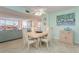Bright dining area with table, chairs, and view to living room at 1 Key Capri # 102E, Treasure Island, FL 33706