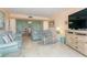 Living room with light teal sofas and coastal decor at 1 Key Capri # 102E, Treasure Island, FL 33706