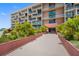Condo building exterior, showing entrance and landscaping at 1 Key Capri # 102E, Treasure Island, FL 33706