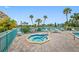 Community hot tub with palm trees and seating at 1 Key Capri # 102E, Treasure Island, FL 33706
