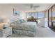 Bedroom with king-size bed, white wicker furniture, and water views at 1 Key Capri # 102E, Treasure Island, FL 33706