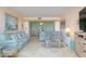 Light and airy living room with light blue sofas and a coffee table at 1 Key Capri # 102E, Treasure Island, FL 33706