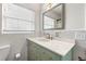 Updated bathroom with a light teal vanity and marble countertop at 800 Pasadena S Ave, St Petersburg, FL 33707