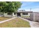 Ranch-style home with a landscaped yard and walkway at 800 Pasadena S Ave, St Petersburg, FL 33707