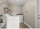 Bright laundry room with white appliances and shelving at 800 Pasadena S Ave, St Petersburg, FL 33707