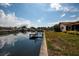 Waterfront backyard with a private dock on a calm canal, perfect for boating and enjoying water views at 165 97Th Ne Ave, St Petersburg, FL 33702