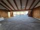 Large living room with wood paneling, vaulted ceiling, and water views at 165 97Th Ne Ave, St Petersburg, FL 33702