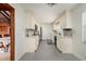 Modern kitchen with light cabinets, stainless steel appliances, and tile flooring at 165 97Th Ne Ave, St Petersburg, FL 33702