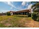Backyard with a screened-in patio and dry, sparse grass at 165 97Th Ne Ave, St Petersburg, FL 33702