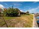 Backyard view of canal front property with lush landscaping at 165 97Th Ne Ave, St Petersburg, FL 33702