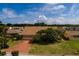 Single-Gathering home with brick paver driveway and mature landscaping at 165 97Th Ne Ave, St Petersburg, FL 33702
