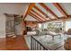 Living room with high ceilings, exposed beams, and spiral staircase at 165 97Th Ne Ave, St Petersburg, FL 33702