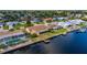 Canal-front property with a pool, dock, and neighboring houses visible at 165 97Th Ne Ave, St Petersburg, FL 33702
