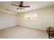 Bright bedroom with ceiling fan, large closet, and window with shutters at 165 97Th Ne Ave, St Petersburg, FL 33702