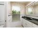Bathroom with granite countertop, vanity, and shower/tub at 165 97Th Ne Ave, St Petersburg, FL 33702