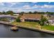 Aerial view showcasing house, pool, dock and canal at 165 97Th Ne Ave, St Petersburg, FL 33702