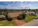 Aerial view of a single-Gathering home with a large yard and brick driveway at 165 97Th Ne Ave, St Petersburg, FL 33702
