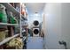 Laundry room with washer, dryer, and ample storage shelves at 165 97Th Ne Ave, St Petersburg, FL 33702