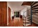 Inviting entryway with wood floors and a spiral staircase leading to the upper level at 165 97Th Ne Ave, St Petersburg, FL 33702