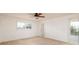 Bedroom with window, ceiling fan and access to patio at 165 97Th Ne Ave, St Petersburg, FL 33702
