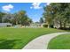 Inviting pool area with lush landscaping and walkway at 7495 Heather Walk Dr, Weeki Wachee, FL 34613