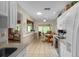 Open concept kitchen with white cabinets, view of living room and dining area at 7495 Heather Walk Dr, Weeki Wachee, FL 34613